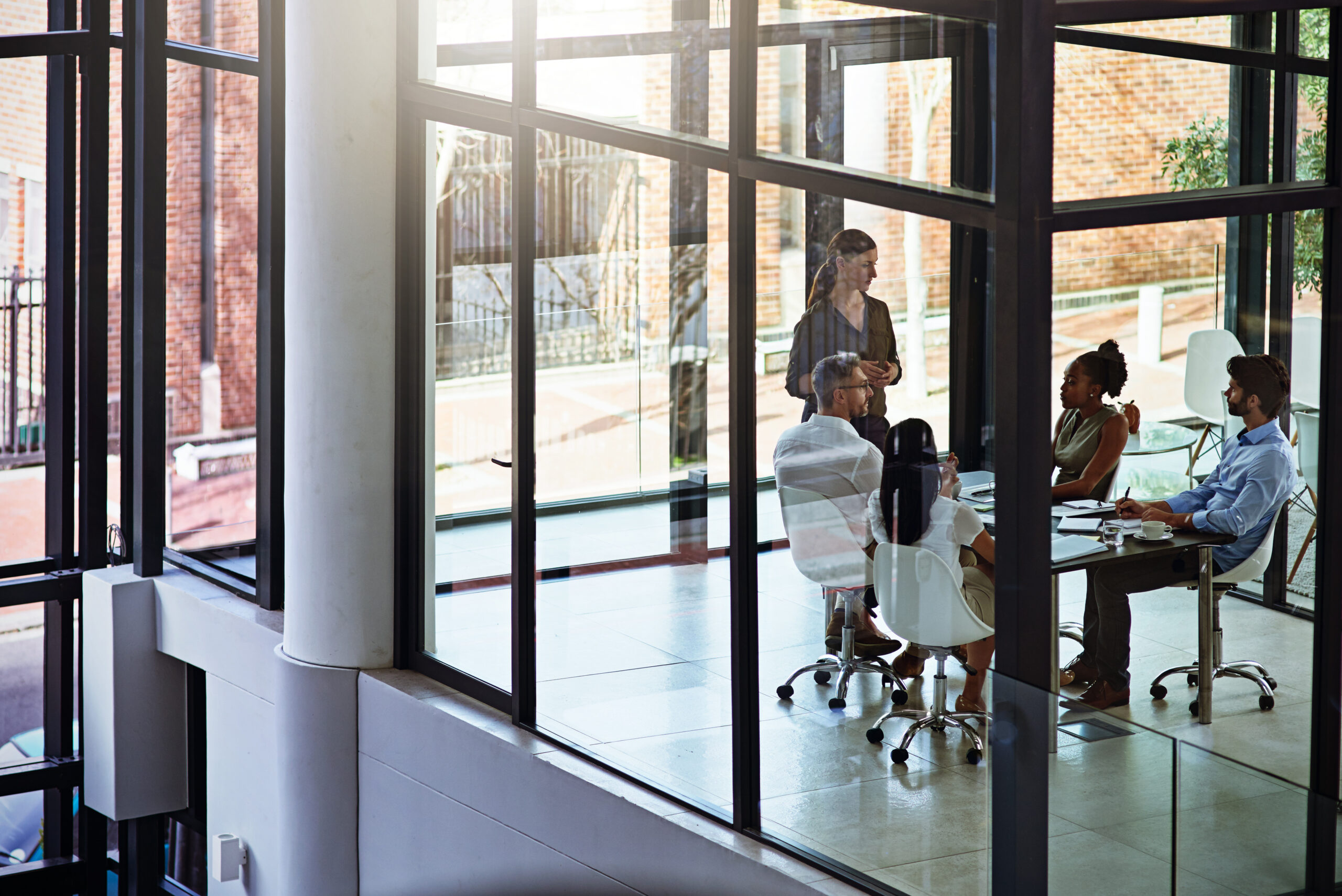 Business meeting in a modern glass conference room